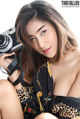 A woman holding a camera in her hand. 