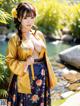 A woman in a yellow and blue kimono posing for a picture.