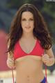 A woman in a red bikini posing for a picture.